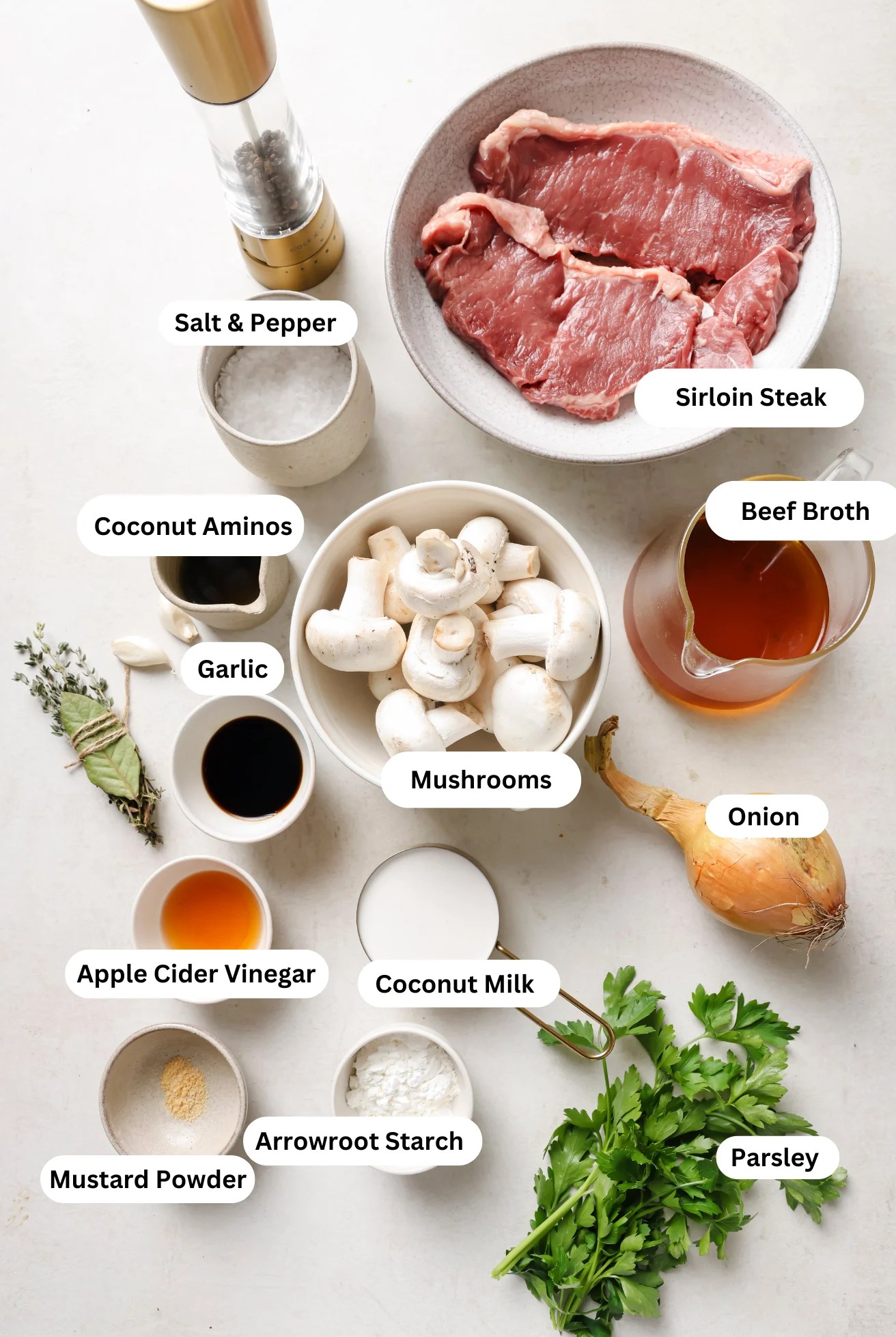 All the ingredients needed for beef stroganoff laid out on a counter before cooking begins.