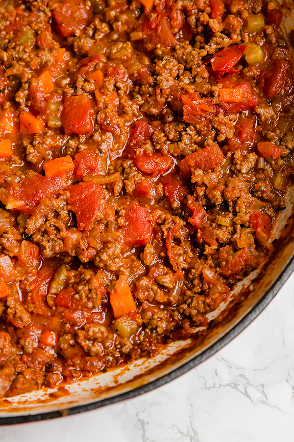 A pot of bolognese sauce ready to be added to gnocchi.