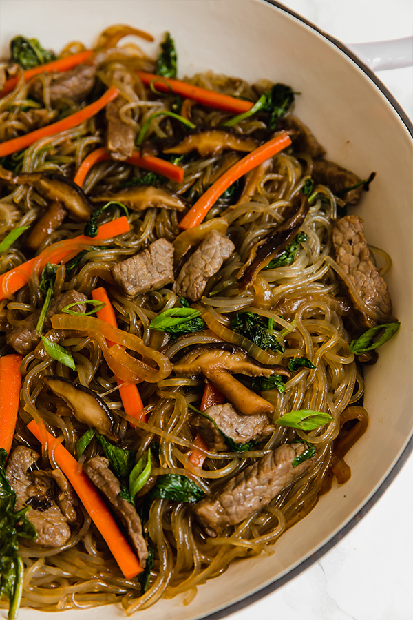 A pan filled with japchae after cooking.