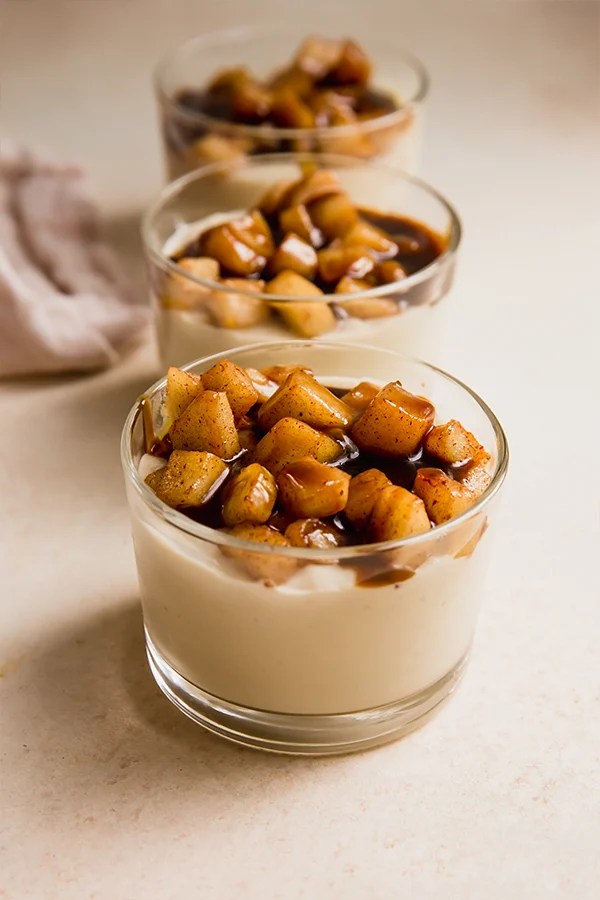 Caramel apple vanilla pudding in small glasses.