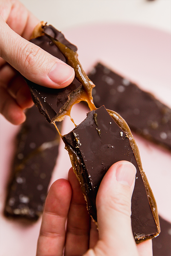 Person breaking a gluten-free Twix bar.