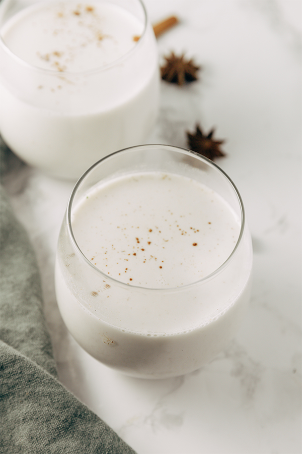 A glass filled with alcoholic paleo eggnog.