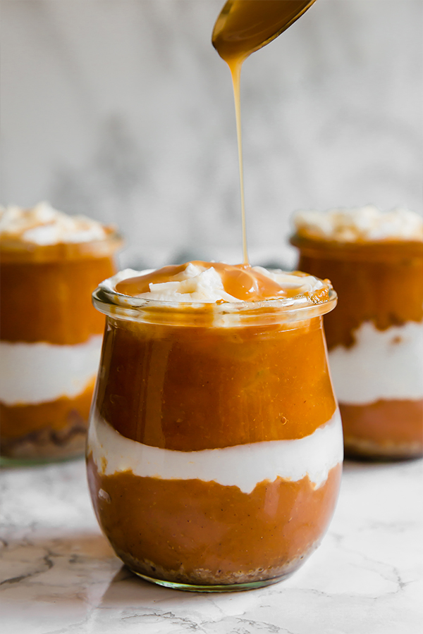 Three glass jars filled with pumpkin parfaits.