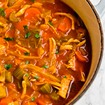 A Dutch oven filled with anti-inflammatory turmeric cabbage soup after cooking.