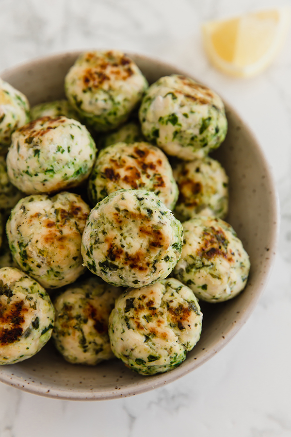 A bowl filled with Mediterranean veggie & chicken meatballs.