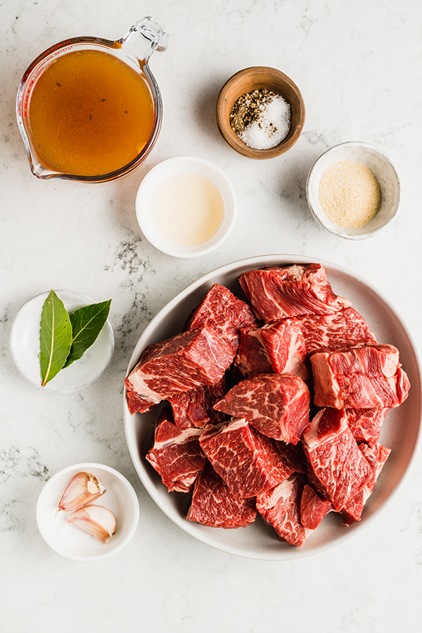Slow cooker shredded beef ingredients in seperate bowls.