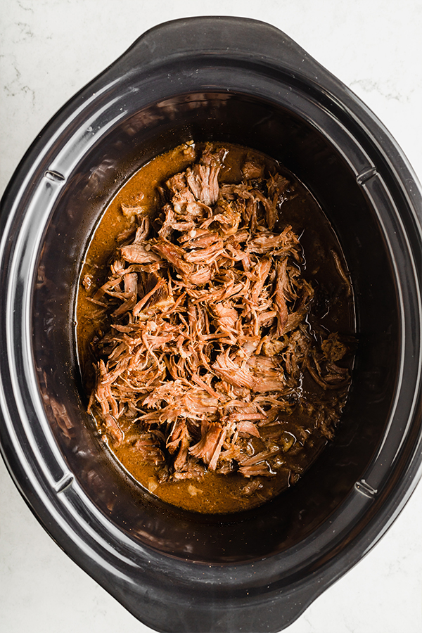Shredded beef in a slow cooker.