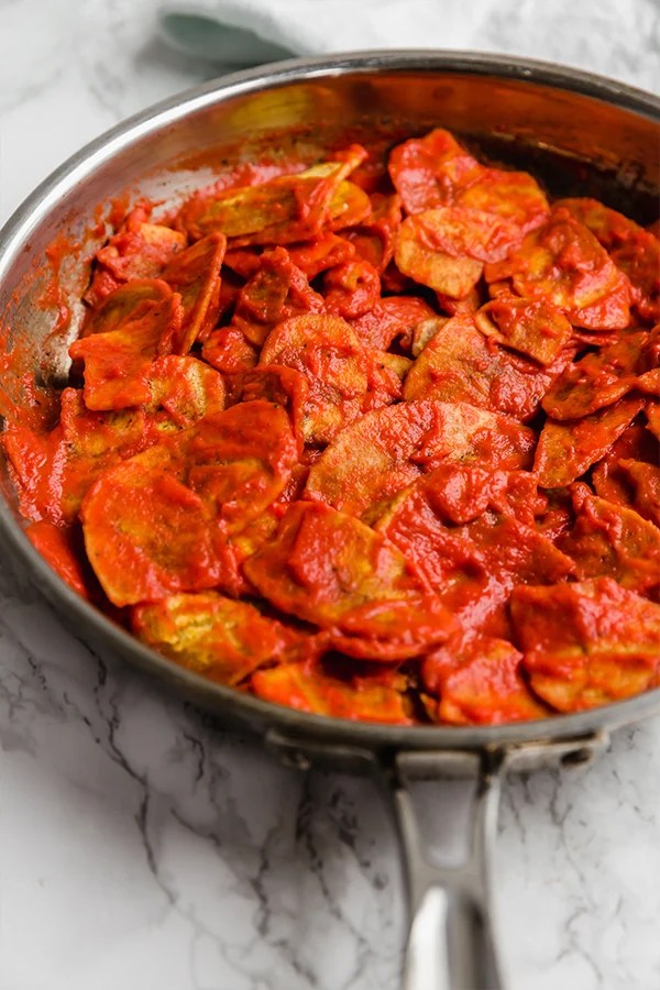 A pan of plantain chilaquiles cooking.