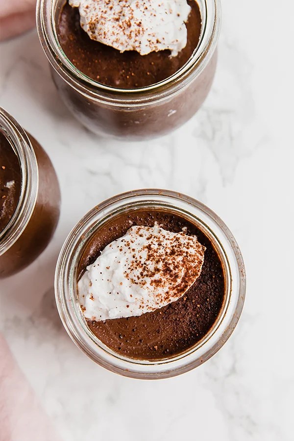 A few glass jars filled with homemade chocolate pudding.