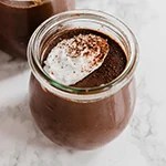 A glass jar filled with homemade chocolate pudding.