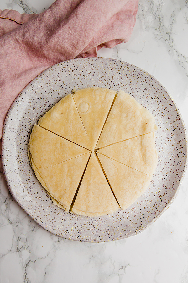 A ceramic plate with tortillas cut up to make cinnamon chips.