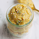 A glass jar filled with edible cake batter.