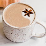 A ceramic mug filled with chai pumpkin spice latte.