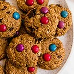 A white plate filled with gluten free monster cookies.