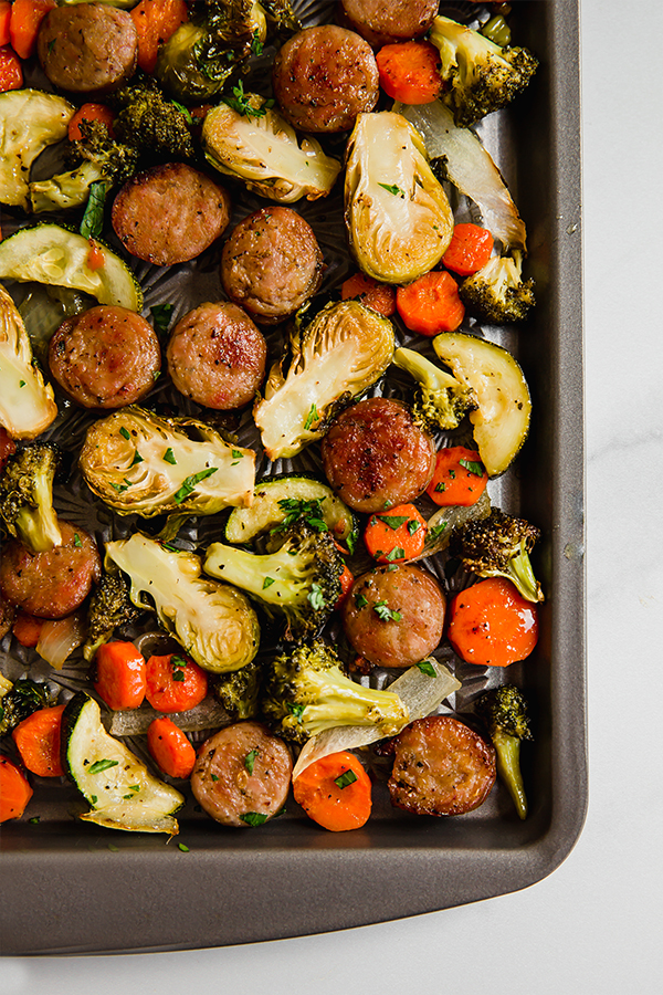 Sausage and vegetables on a sheet pan.