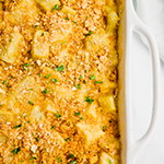 A baking dish filled with a cheesy sweet potato casserole after baking.