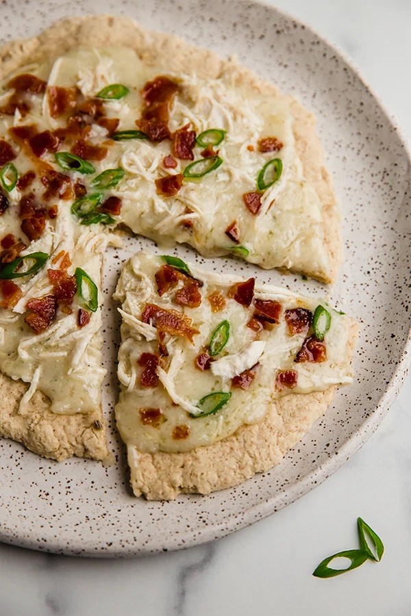 Bacon ranch chicken pizza topped with bacon and green onion