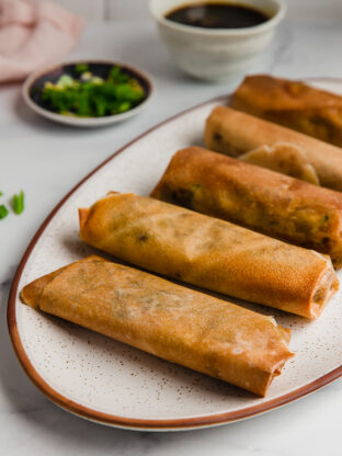 A platter of cooked air fryer egg rolls.