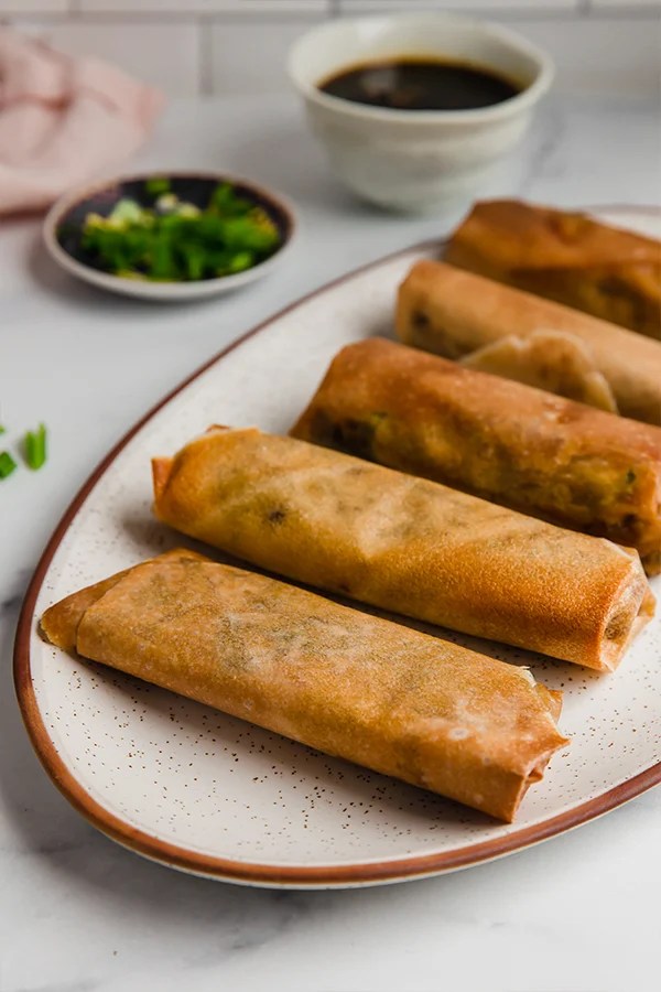 A platter of cooked air fryer egg rolls.