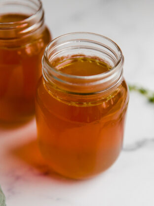 Glass jars of bone broth.