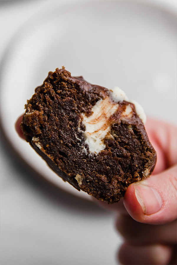 half of ding dong cupcake in hand