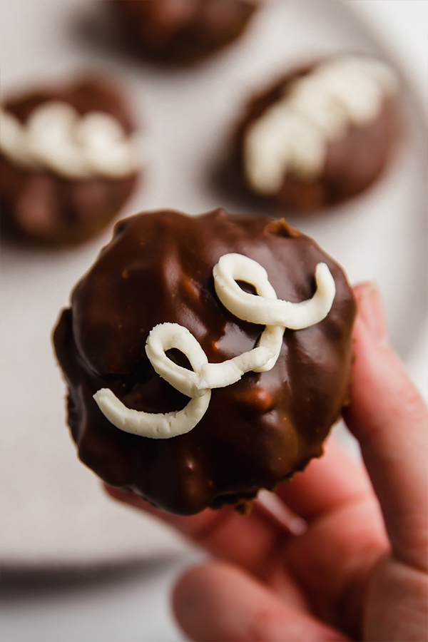 ding dong cupcakes on plate, one in hand