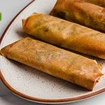 A platter of cooked air fryer egg rolls.