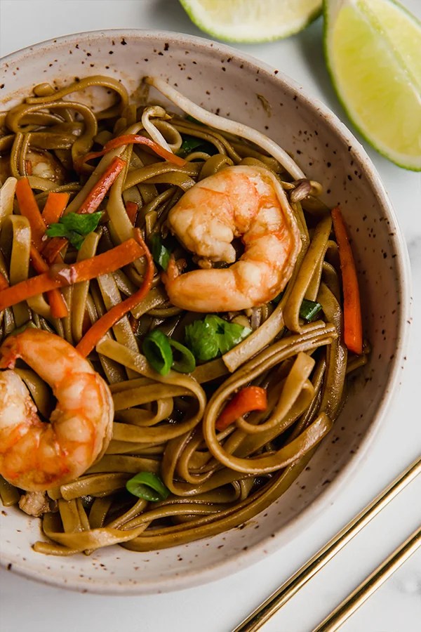 Shrimp in a bowl of gluten-free Pad Thai.