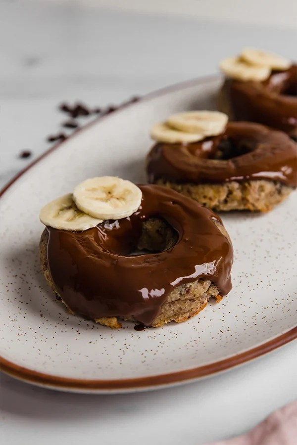 Banana bread donuts on a platter.