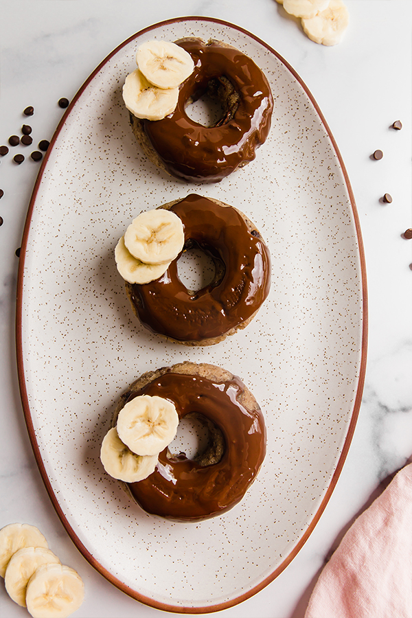 three banana bread donuts on a plate.