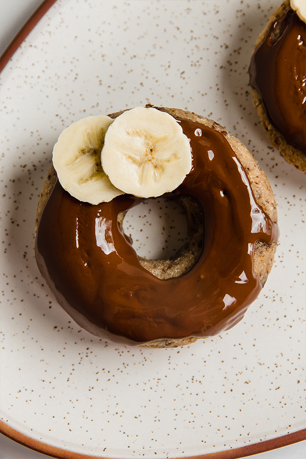 Banana slices on a banana bread donut.