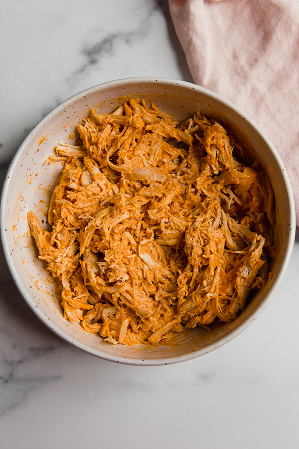 Buffalo chicken mixed in a bowl
