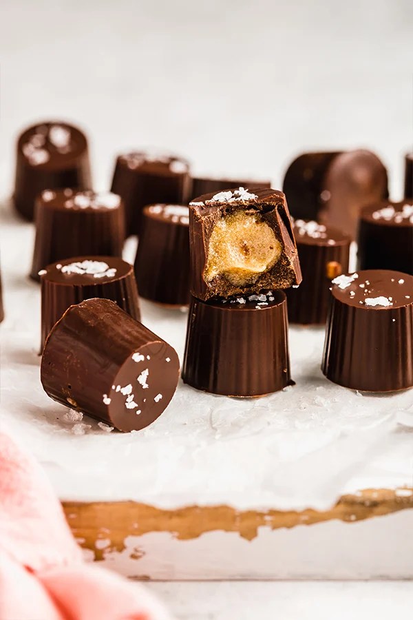 Several salted caramel cups, one of which is missing a bite.