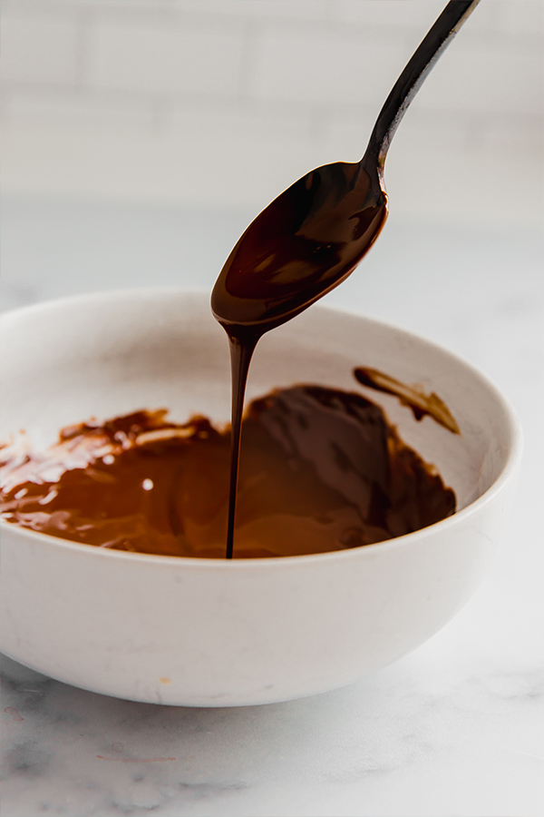 Melted chocolate dripping from a spoon