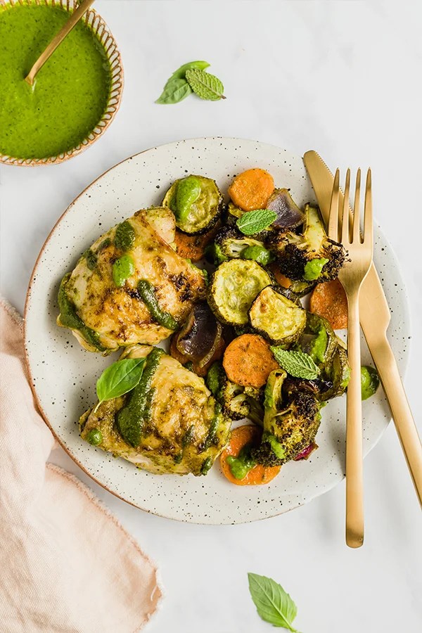 chicken pesto on plate with pesto sauce on side