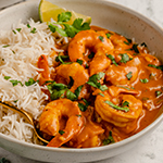 Shrimp curry in a bowl with rice.