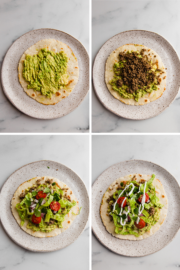 Grain free tostadas being assembled with avocado, beef, then toppings