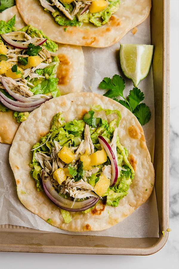 Mango tostadas assembled on pan ready to eat