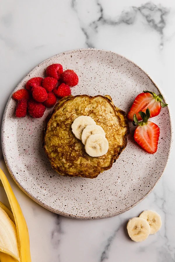pancakes on a plate topped with banana