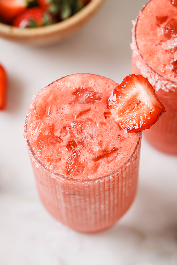 Glass of strawberry margarita mocktail with ice.