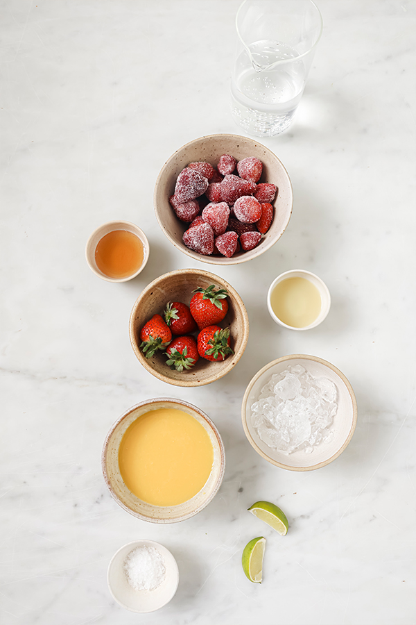 Ingredients including orange juice, honey, and frozen strawberries.