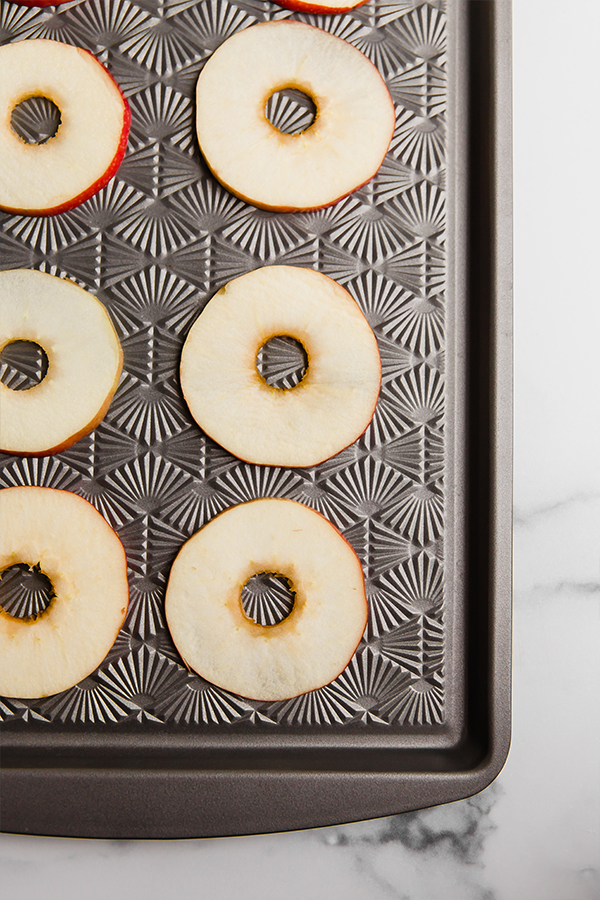 Apple slices on sheet pan ready to put on toppings