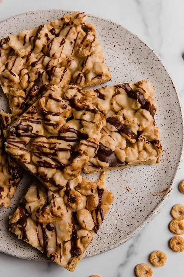 Cereal bars drizzled with chocolate on a plate.