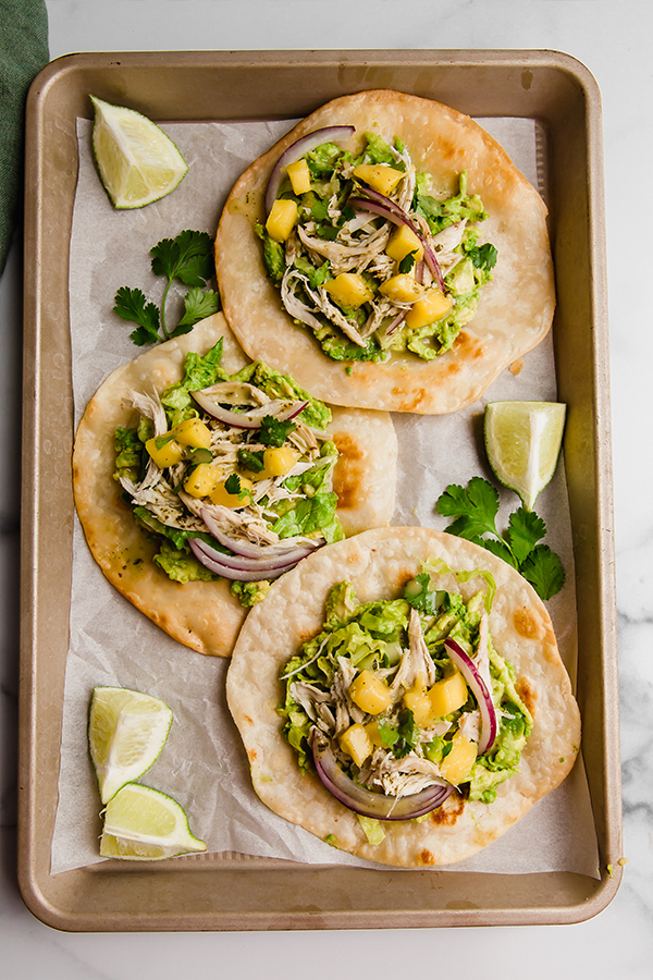 Top view of 3 tostadas on a sheet pan
