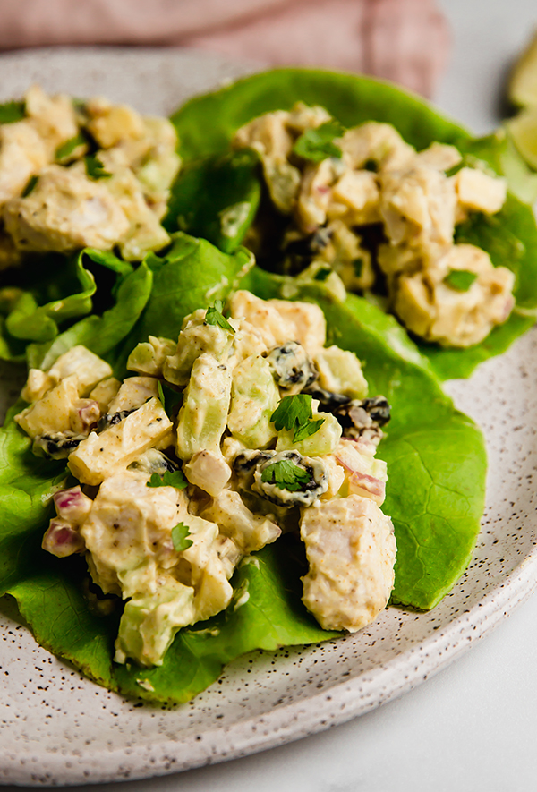 Yogurt curry chicken salad served on butter lettuce on a plate