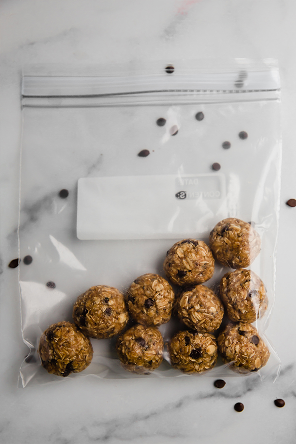 Energy bites rolled and put in plastic bag ready to set in the fridge