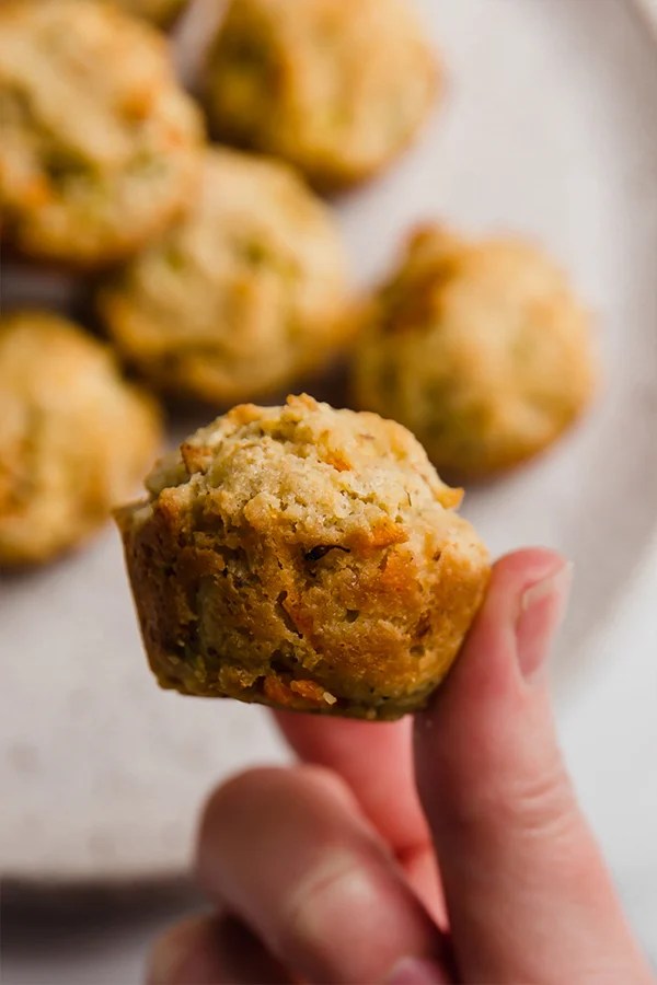 Person holding a gluten-free veggie muffin.