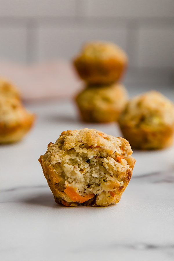 Gluten-free veggie muffin missing a bite.