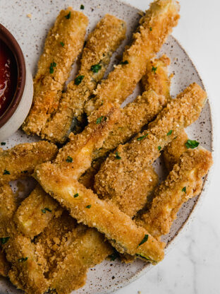 Zucchini fries piled on a plate.