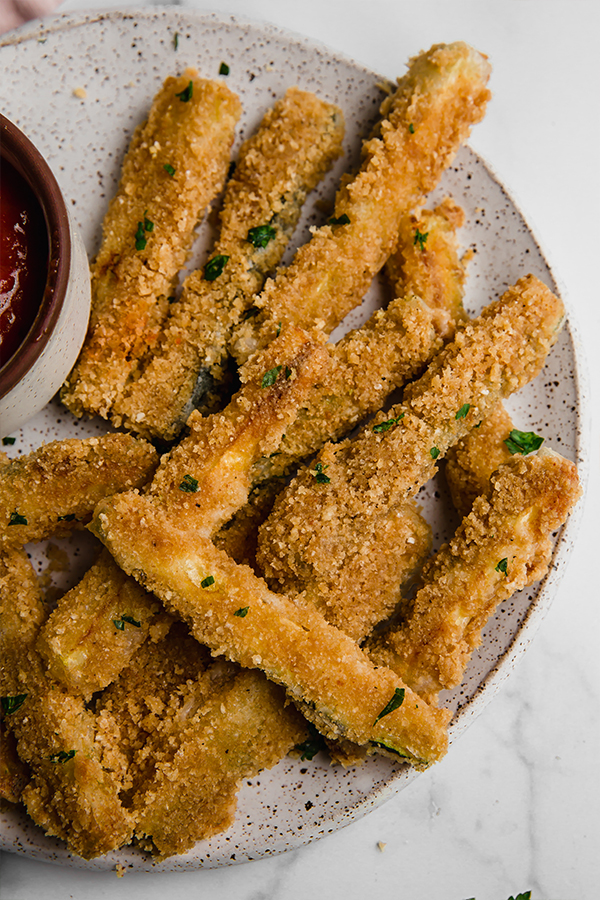 Zucchini fries piled on a plate.